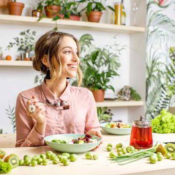 A woman enjoying a nourishing meal among her plants